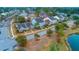 Aerial of a colorful neighborhood with sidewalks and palm trees lining the street; lakeside property at 1608 Fetterbush Ln, Johns Island, SC 29455