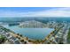 Panoramic aerial view of a neighborhood with colorful houses surrounding a large lake; a serene community setting at 1608 Fetterbush Ln, Johns Island, SC 29455