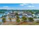 Overhead view of a residential area with pond featuring a variety of colorful houses and mature trees at 1608 Fetterbush Ln, Johns Island, SC 29455