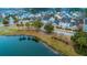 Aerial view of lakefront colorful homes and tree lined streets showcase this neighborhood at 1608 Fetterbush Ln, Johns Island, SC 29455