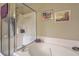 Bright bathroom with a luxurious soaking tub and a separate shower with clear glass door at 1608 Fetterbush Ln, Johns Island, SC 29455