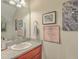 Clean bathroom with granite countertop, modern sink, and decorative wall art at 1608 Fetterbush Ln, Johns Island, SC 29455