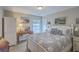 Cozy bedroom features a white wood bed frame, blue and white quilt and access to ensuite bathroom at 1608 Fetterbush Ln, Johns Island, SC 29455