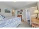 Light-filled bedroom boasts an ensuite bathroom and soothing decor with a white wood bed frame at 1608 Fetterbush Ln, Johns Island, SC 29455
