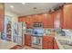 Well-lit kitchen featuring stainless steel appliances, granite countertops, and wooden cabinetry at 1608 Fetterbush Ln, Johns Island, SC 29455