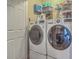 Functional laundry room with side-by-side LG washer and dryer and built in wire rack shelving at 1608 Fetterbush Ln, Johns Island, SC 29455