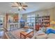 Inviting living room with hardwood floors, a ceiling fan, and an open view into the kitchen area at 1608 Fetterbush Ln, Johns Island, SC 29455