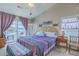 Comfortable main bedroom with a ceiling fan, and access to a private balcony with water view at 1608 Fetterbush Ln, Johns Island, SC 29455