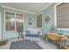 Cozy covered porch with wicker furniture, a decorative rug, and aqua-painted walls at 1608 Fetterbush Ln, Johns Island, SC 29455