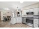 Bright kitchen features granite countertops, stainless steel appliances, eat-in breakfast area, and painted white cabinetry at 172 Paddock Way, Summerville, SC 29486