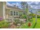 Cozy backyard patio with outdoor seating, lush landscaping, and a charming fence at 206 President Cir, Summerville, SC 29483