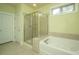 Bright bathroom featuring a soaking tub and separate tiled shower at 206 President Cir, Summerville, SC 29483