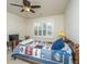 Cozy bedroom with ceiling fan, window with shutters, and sports-themed quilt at 206 President Cir, Summerville, SC 29483
