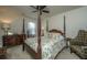 Spacious bedroom with large canopy bed, detailed wood furniture, ceiling fan and natural light at 206 President Cir, Summerville, SC 29483