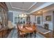 Sophisticated dining room with a wooden table, stylish chandelier, and a view into the next room at 206 President Cir, Summerville, SC 29483
