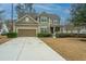 Traditional two-story home with a well-manicured front yard and attached two car garage at 206 President Cir, Summerville, SC 29483