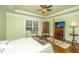 Bright primary bedroom featuring hardwood floors, a sitting area and a television at 206 President Cir, Summerville, SC 29483