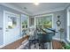 Bright sunroom with a piano and views to the door and backyard at 206 President Cir, Summerville, SC 29483