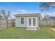 Well maintained storage shed with double doors and a window, set in a lush, grassy backyard at 209 Persimmon Cir, Goose Creek, SC 29445