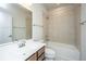 Well-lit bathroom with a single sink vanity, shower and tub combo, and neutral tile at 219 Corvus St, Summerville, SC 29483