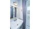 Stylish bathroom with a modern sink, mirror, and soft gray curtains near the window at 219 Corvus St, Summerville, SC 29483