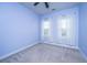 Bedroom painted a soft blue, with carpet, two windows, and light-blocking curtains at 219 Corvus St, Summerville, SC 29483