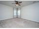 Spacious, carpeted bedroom with neutral walls, ceiling fan, and plenty of natural light from two windows at 219 Corvus St, Summerville, SC 29483