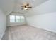 Spacious bonus room with neutral carpet, ceiling fan, and a large window for natural light at 219 Corvus St, Summerville, SC 29483