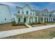 Inviting two-story home boasting a classic porch, a dark front door, and well-maintained landscaping at 219 Corvus St, Summerville, SC 29483