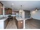 Modern open-concept kitchen with stainless steel appliances, granite countertops and wood floors at 219 Corvus St, Summerville, SC 29483