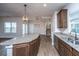 Well-lit kitchen showcasing granite countertops, stainless steel appliances, and rich wood cabinets at 219 Corvus St, Summerville, SC 29483