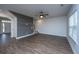 Bright living room featuring hardwood floors, a ceiling fan, and a modern accent wall at 219 Corvus St, Summerville, SC 29483