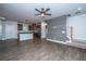 Open-concept living area with hardwood floors, a ceiling fan, and a kitchen view at 219 Corvus St, Summerville, SC 29483