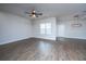 Bright living room boasts wood-look flooring, a modern ceiling fan, and ample natural light at 219 Corvus St, Summerville, SC 29483