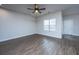 Bright living room featuring modern ceiling fan, window with blinds, light gray walls, and beautiful wood-look flooring at 219 Corvus St, Summerville, SC 29483