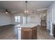 Open-concept living room featuring a stylish ceiling fan, hardwood floors, and natural light at 219 Corvus St, Summerville, SC 29483