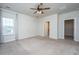 Spacious main bedroom with a ceiling fan, carpet, and access to the ensuite and walk-in closet at 219 Corvus St, Summerville, SC 29483