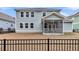A fenced backyard view features a spacious yard and a charming home with a screened porch at 295 Calm Water Way, Summerville, SC 29486