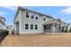 A fenced backyard view features a spacious yard and a charming home with a screened porch at 295 Calm Water Way, Summerville, SC 29486
