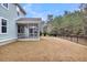 A fenced backyard view features a spacious yard and a charming home with a screened porch at 295 Calm Water Way, Summerville, SC 29486