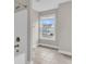 Well-lit bathroom featuring a shower/tub, and a large window with a neighborhood view at 295 Calm Water Way, Summerville, SC 29486