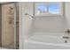 Bright bathroom featuring a shower, soaking tub, and a window letting in natural light at 295 Calm Water Way, Summerville, SC 29486