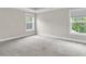 Spacious bedroom filled with natural light, complimented by new carpet, ready for personalization at 295 Calm Water Way, Summerville, SC 29486