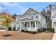 Charming two-story home with a manicured lawn and a inviting front porch at 295 Calm Water Way, Summerville, SC 29486