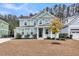Charming two-story home features a welcoming front porch and manicured landscaping at 295 Calm Water Way, Summerville, SC 29486