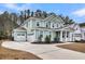 Spacious two-car garage and long driveway enhance this charming two-story home at 295 Calm Water Way, Summerville, SC 29486