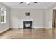 Cozy fireplace with a black mantel and hardwood floors in a neutral room at 295 Calm Water Way, Summerville, SC 29486
