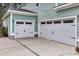 Spacious two-car garage features white doors and convenient access to the home at 295 Calm Water Way, Summerville, SC 29486