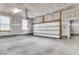 Spacious garage with concrete floor and white door, offering ample parking and storage space at 295 Calm Water Way, Summerville, SC 29486