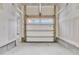 Clean, partially finished garage with a new white door, offering lots of potential at 295 Calm Water Way, Summerville, SC 29486